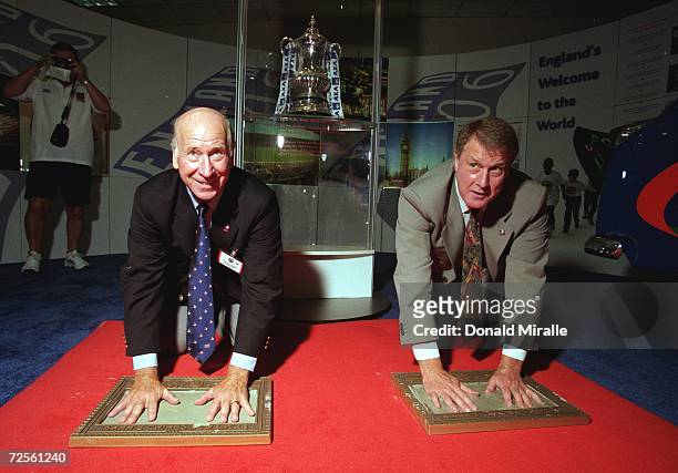 Sir Bobby Charlton and Sir Geoff Hurst place their hands in cement during the Soccerex ''99 at the Century Plaza Hotel in Century City, California....