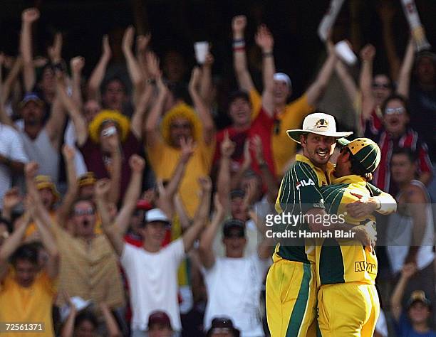 Michael Kasprowicz of Australia celebrates with team mate Ricky Poning after taking a catch to dismiss Dwayne Bravo of the West Indies during game...