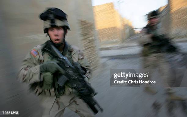 Soldiers with the 1st Battalion, 5th Infantry Stryker Brigade Combat Team of the 25th Infantry Division out of Ft. Lewis, Washington react as shots...