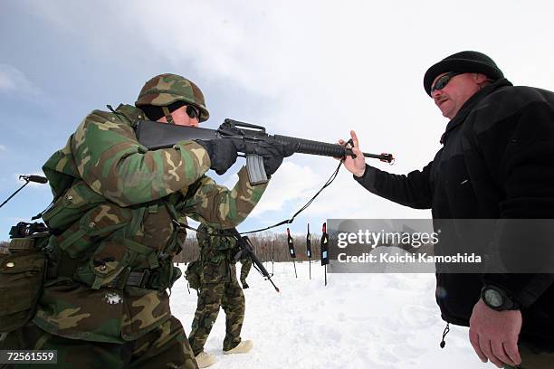 Military personnel take part in a joint training drill with the Japan Ground Self Defence Forces and the U.S. Army March 3, 2005 in Higashi Chitose,...