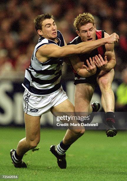Cory Enright for Geelong and Gary Moorcroft for Essendon in action during the round 15 AFL match played between the Essendon Bombers and the Geelong...