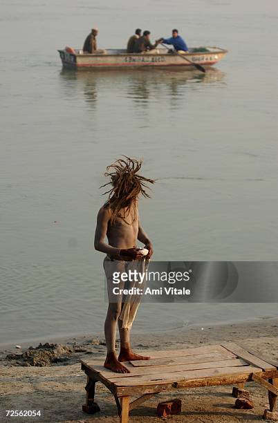 Hindu pilgrim bathes March 9, 2002 as Indian police patrol the river banks to keep more pilgrims from entering the northern Indian city of Ayodhya....