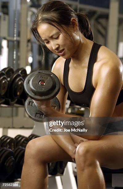 Golfer Virada Nirapathpongporn, a 2004 Duke University graduate and star golfer, pumps some iron in the Duke gym, 2004 in Durham, North Carolina....