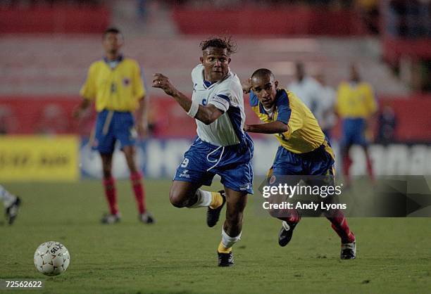 Carlos Alberto Pavon of Team Honduras runs for the ball as Roberto Carlos Cortes of Team Columbia runs behind him during the Gold Cup 2000 Game at...