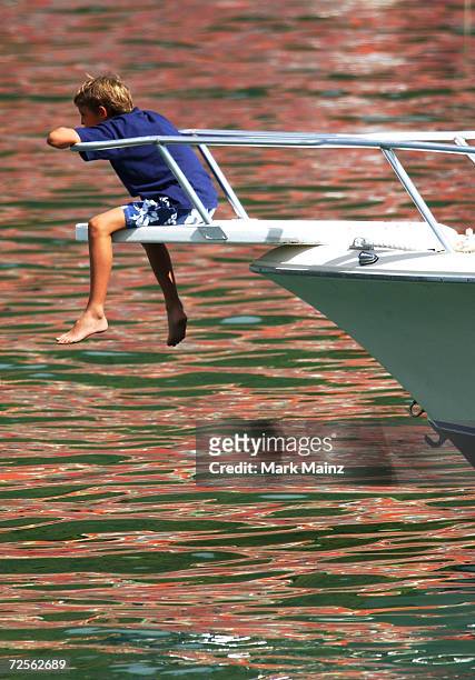 Person sits on a boat in Gustavia harbor December 27, 2002 in St. Barthelemy, French West Indies.