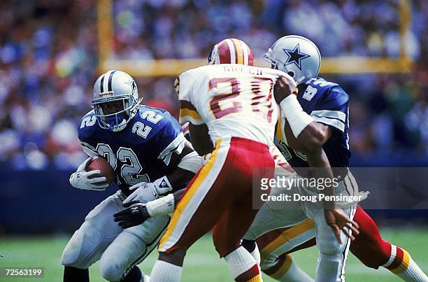 Emmitt Smith of the Dallas Cowboys carries the ball during a game against the Washington Redskins. The Redskins defeated the Cowboys 19-15. Mandatory...