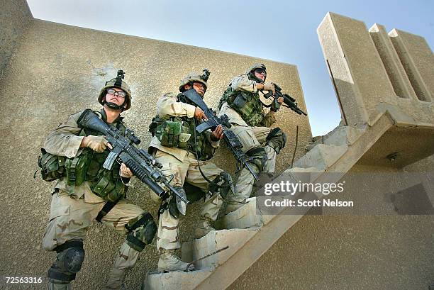 Army soldiers from the 1st Infantry Division's 2nd Battalion-2nd Regiment clear abandoned houses of insurgent fighters November 10, 2004 during...