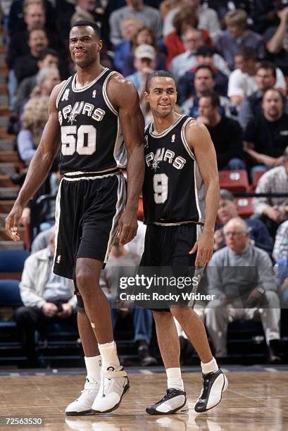 Center David Robinson of the San Antonio Spurs walks with point guard Tony Parker during the NBA game against the Sacramento Kings at Arco Arena in...