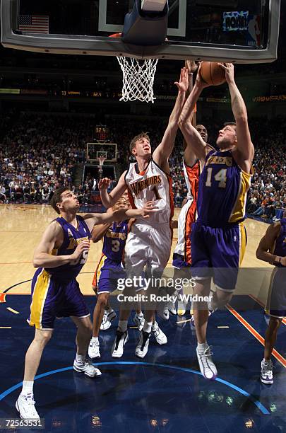 Stanislav Medvedenko of the Los Angeles Lakers goes to the basket against Troy Murphy of the Golden State Warriors during their game at the Arena in...