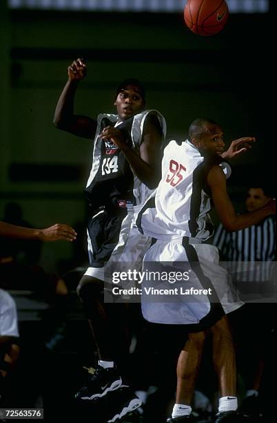 Kareem Rush passing the ball around Keith Kincade during the Nike High School Basketball Camp in Indianapolis, Indiana.