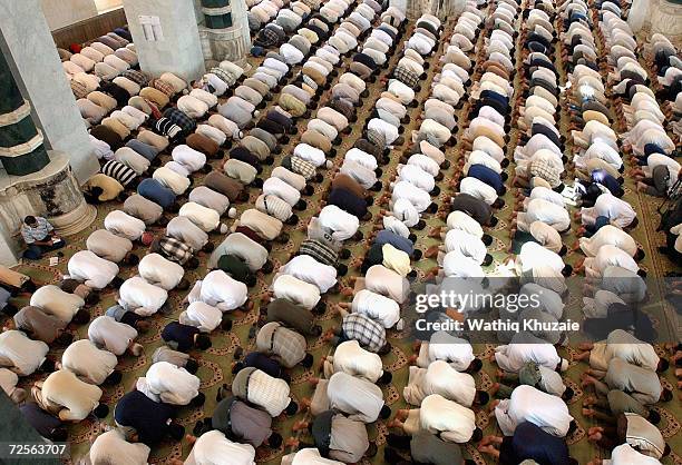 Iraqi Sunni Muslims pray during Friday prayers in Umm al-Qura mosque September 3, 2004 Baghdad, Iraq. The clerics of Umm al-Qura mosque are engaged...