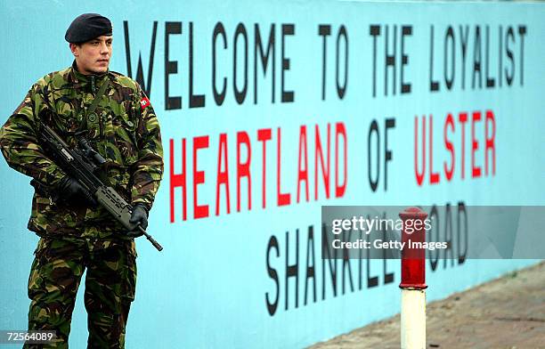 British army soldiers patrol the Lower Shankill area in front of a mural by the Ulster Defense Association , the largest Protestant paramilitary...