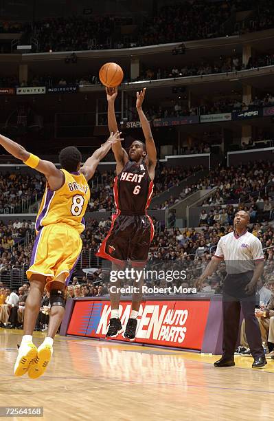 Guard Eddie Jones of the Miami Heat shoots the ball as guard Kobe Bryant of the Los Angeles Lakers attempts to block during the NBA game at the...