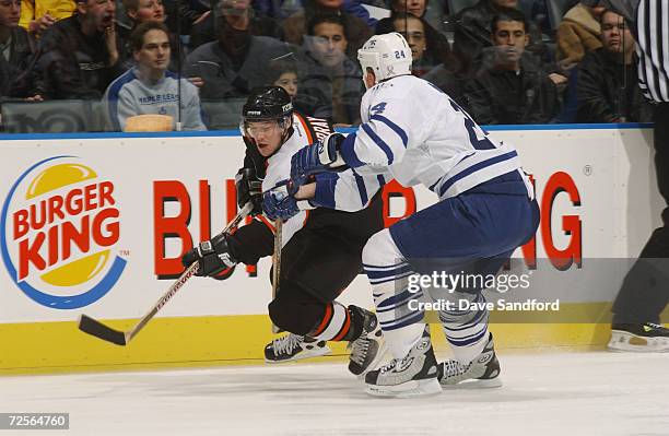 Marty Murray of the Philadelphia Flyers gets cut off by Bryan McCabe of the Toronto Maple Leafs during the game at Air Canada Centre in Toronto,...