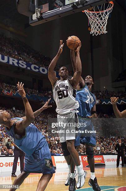 David Robinson of the San Antonio Spurs goes to the basket defended by Kevin Garnett of the Minnesota Timberwolves during their game at the Alamodome...