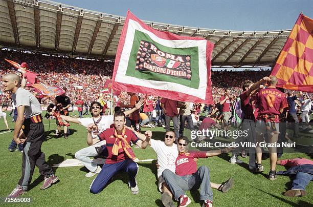 Roma fans celebrate the Scudetto by invading the pitch after a 3-1 victory in the Serie A match against Parma at the Stadio Olimpico in Rome....