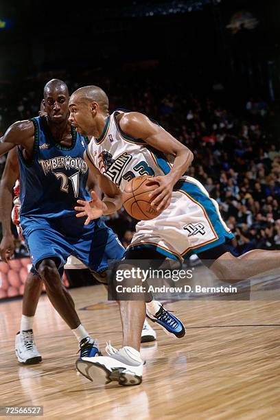 Grant Hill of the Eastern Conference All-Stars drives to the basket against Kevin Garnett of the Western Conference All-Stars during the 2000 NBA...