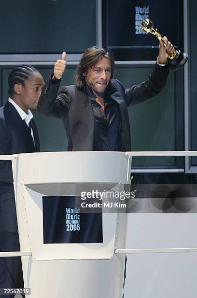 French DJ Bob Sinclar, receives the World's Best DJ award from Lemar on stage during the 2006 World Music Awards at Earls Court on November 15, 2006...