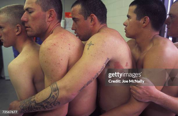 Navy Seal trainees huddle together for warmth in this undated photo taken in 2000 at the Coronado Naval Amphibious Base in San Diego, California....