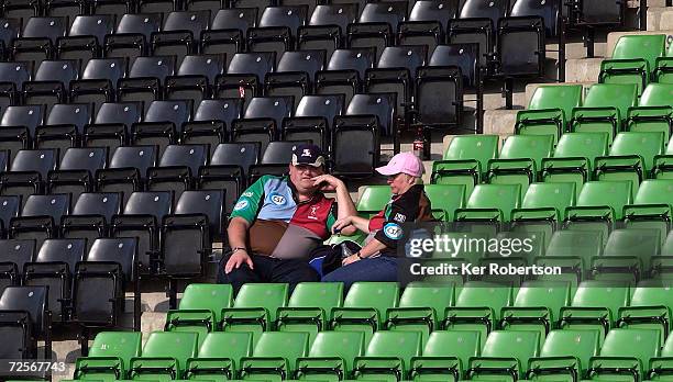 Two disappointed NEC Harlequins fans sit in the stand following his teams defeat during the Zurich Premiership match between NEC Harlequins and Sale...