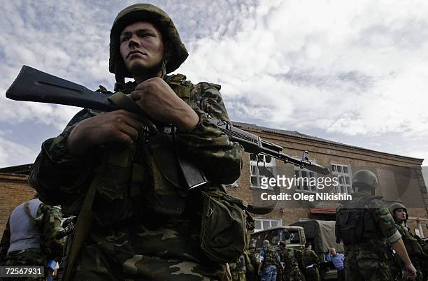 An armed soldier surveys the area after special forces stormed a school seized by Chechen separatists on September 3, 2004 in the town of Beslan,...
