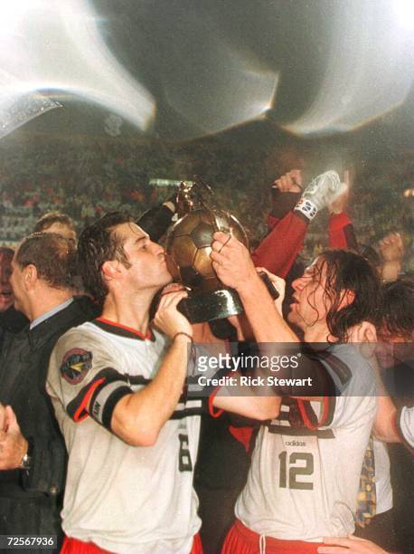 John Harkes and Jeff Agoos of DC United hoist the Alan I Rothenberg Cup after their team defeated the Los Angeles Galaxy in the Major League Soccer...