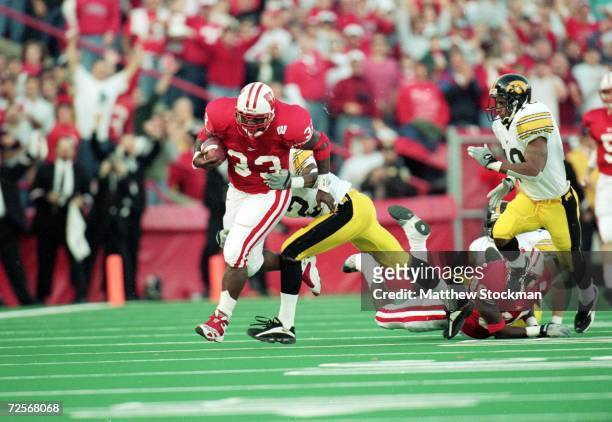 Ron Dayne of the Wisconsin Badgers carries the ball for a 32yard gain for a NCAA record during the game against the Iowa Hawkeyes at the Camp Randall...