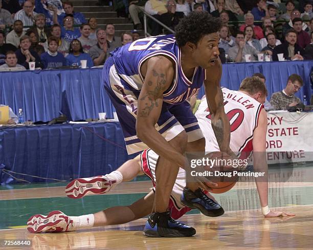 Justin Tatum of Saint Louis University grabs a loose ball from a diving Phil Cullen of the University of Utah in round one of the Midwest Regional of...