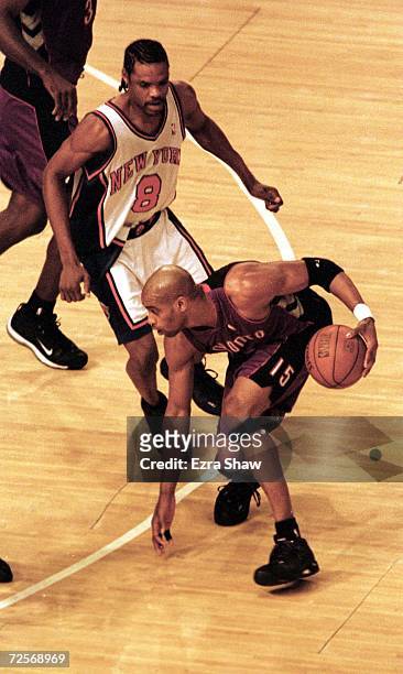 Vince Carter of the Toronto Raptors gets set against Latrell Sprewell of the New York Knicks during Game 2 of the first round of the quarter-finals...