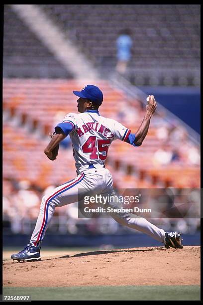 Pitcher Pedro Martinez of the Montreal Expos lunges forward to deliver a pitch against the San Diego Padres at Jack Murphy Stadium in San Diego,...