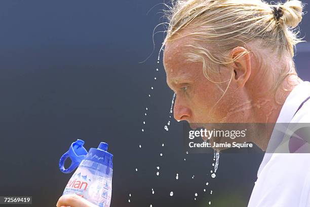 Kenneth Carlsen of Denmark cools off during his match with Xavier Malisse of Belgium during the first round of the US Open at the USTA National...