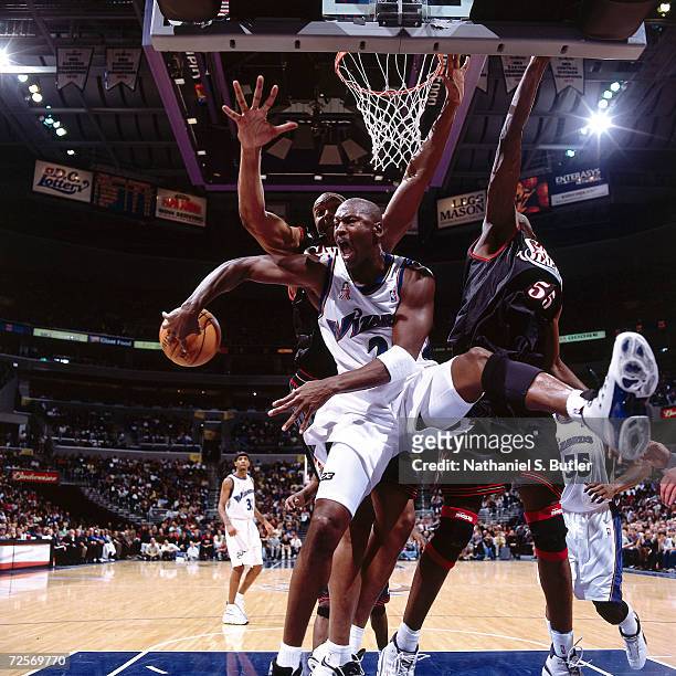 Michael Jordan of the Washington Wizards passes behind his back against the Philadelphia 76ers during the NBA game at the MCI Center in Washington,...