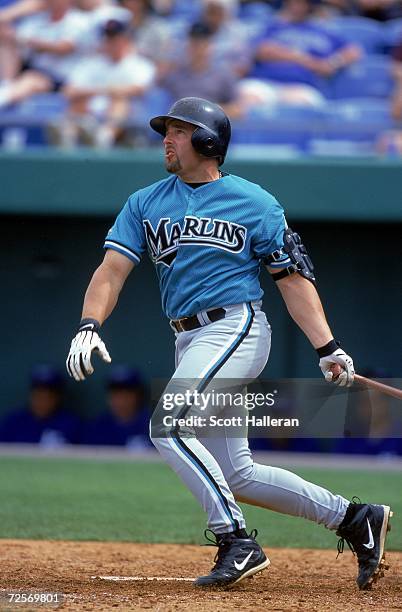 Kevin Millar of the Florida Marlins starts to run after hitting the ball during the Spring Training Game against the Kansas City Royals at Baseball...