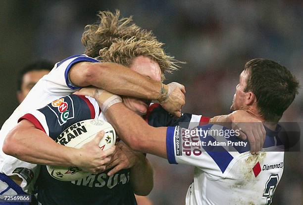 Ryan Cross of the Roosters is tackled during the NRL Grand Final between the Sydney Roosters and the Bulldogs held at Telstra Stadium, October 3,...