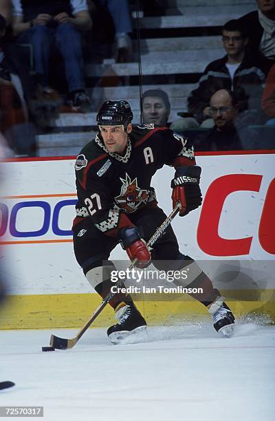 Teppo Numminen of the Phoenix Coyotes moves with the puck during the game against the Calgary Flames at the Canadian Airlines Saddledome in Calgary,...