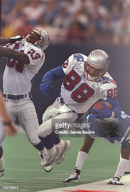 Wide receiver Terry Glenn of the New England Patriots is hit out of bounds by defensive back Ray Buchanan of the Indianapolis Colts during the...
