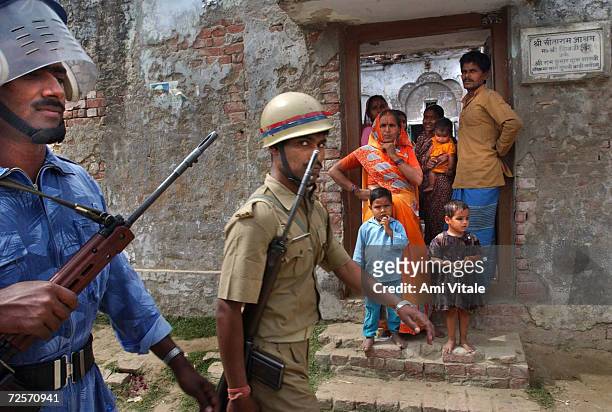 Members of the Indian Rapid Action Force conduct a flag march March 14, 2002 through the streets of the disputed northern Indian city of Ayodhya. The...