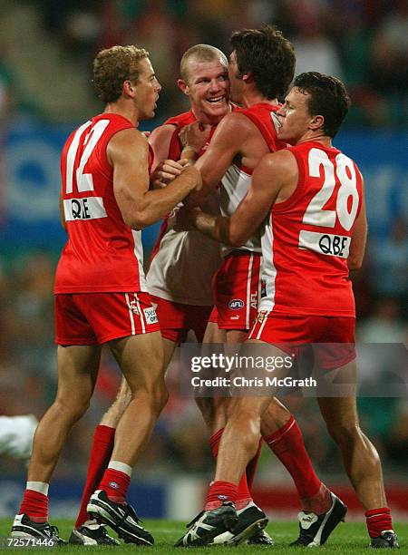 Barry Hall of the Swans is congratulated by team mates after kicking a goal during the round 4 AFL match between the Sydney Swans and the Kangaroos...