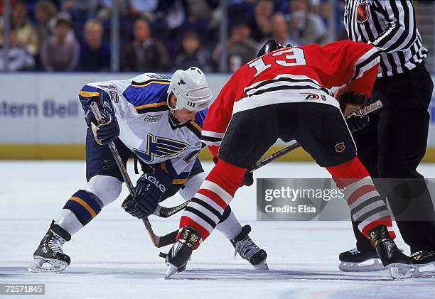 Marty Reasoner of the St. Louis Blues faces off with Alexei Zhamnov of the Chicago Blackhawks at the Kiel Center in St. Louis, Missouri. The...