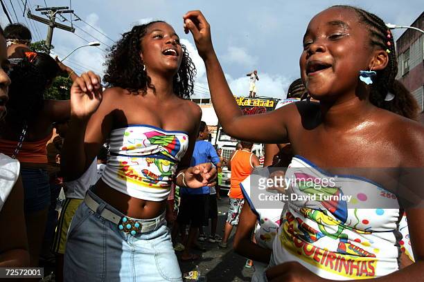 Young girls dance through the streets during Carnival on February 7, 2005 in Salvador, Brazil. Centuries of slave trade with Central and West Africa...