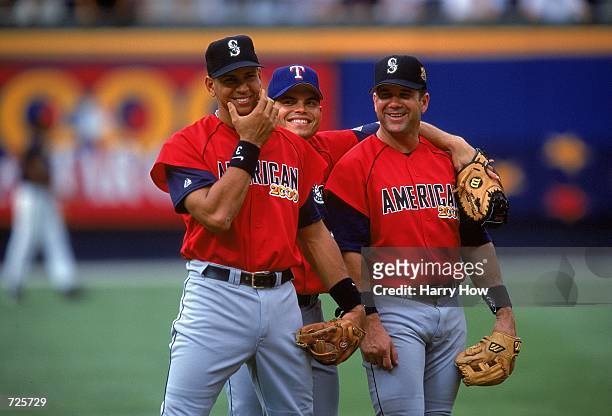 Alex Rodriguez, Ivan Rodriguez, and Edgar Martinez who play for the American League walk and smile for the camera during the All-Star Game against...
