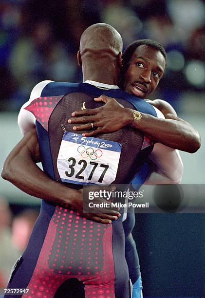 Michael Johnson of the USA is congratulated by compatriot and silver medallist Alvin Harrison after winning gold in the Mens 400m Final in the...
