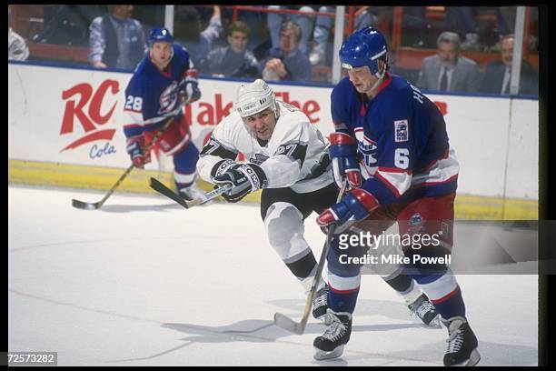 Leftwinger John Tonelli of the Los Angeles Kings works against the Winnipeg Jets during a game at the Great Westen Forum in Inglewood, California....