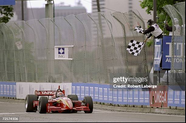 Alex Zanardi/ITA of team Target/Chip Gnassi and driver of the Reynard Honda 98I crosses the finish line first during the Detroit Grand Prix in...