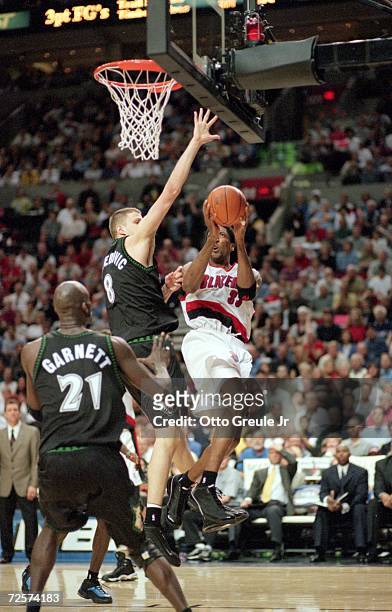 Scottie Pippen of the Portland Trailblazers makes a layup as he is blocked by Radoslav Nesterovic of the Minnesota Timberwolves during the NBA...