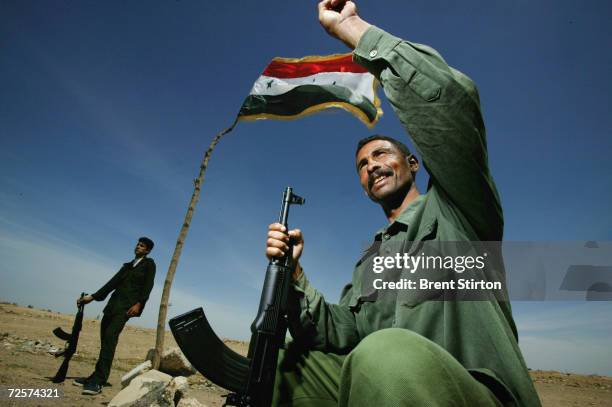 Hassan Falib Ali and Ali Dulame , members of the new Iraqi army, pose for a portrait May 6, 2004 in Fallujah, Iraq. Although not yet involved in...