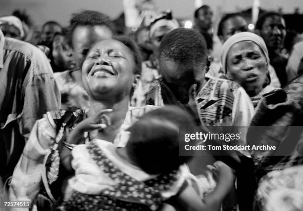 Congregation prays for deliverance from the HIV/AIDS virus during an open air rally in Mombassa. As sub-Saharan Africans cannot afford...