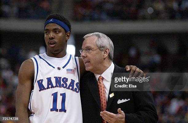 Head coach Roy Williams of Kansas talks with Aaron Miles in the second half against Oregon during the NCAA Mens Basketball Tournament at the Kohl...