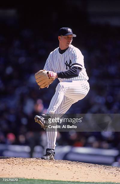 David Cone of the New York Yankees winds back to pitch the ball during the game against the Texas Rangers at the Yankee Stadium in Bronx, New York....