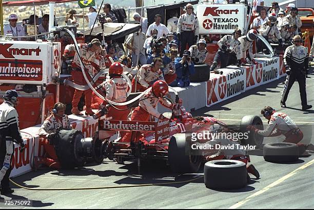 Driver Christian Fittapaldi of Brazil and the Newman Haas Racing team receives work on his Lola Ford 96 during a pit stop in the IndyCar PPG World...